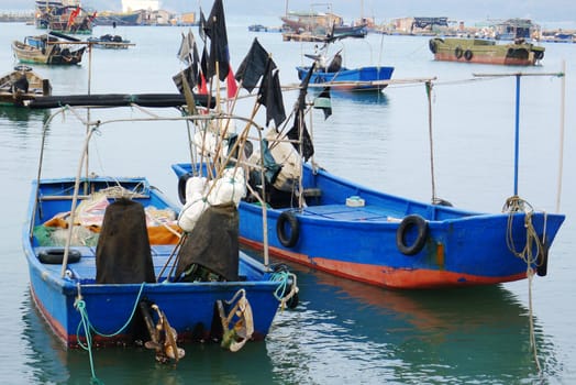 Blue fishing boats at seashore