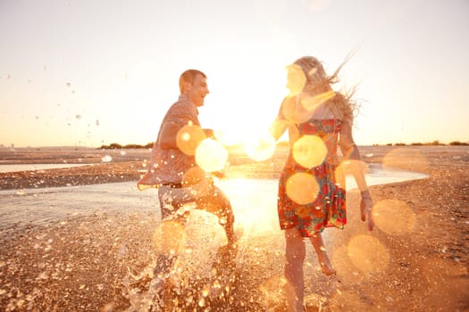 happy couple running on the beach