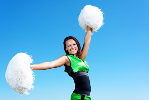 cheerleader girl on a background of blue sky