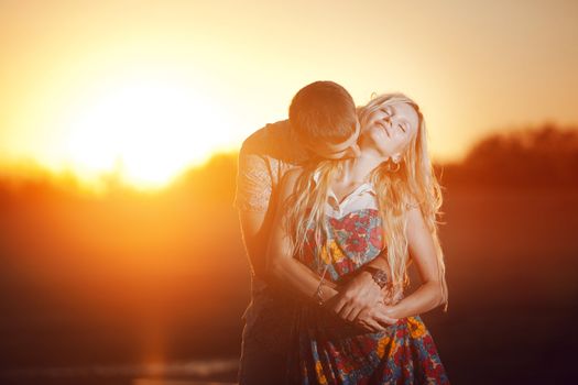 happy couple kissing on the beach