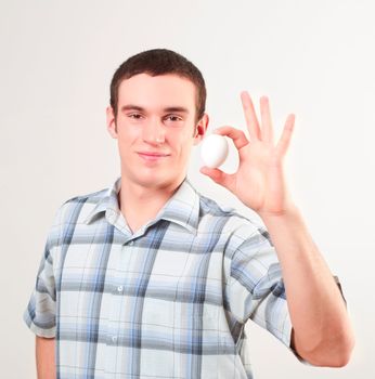 portrait of a young man, hold egg, ok