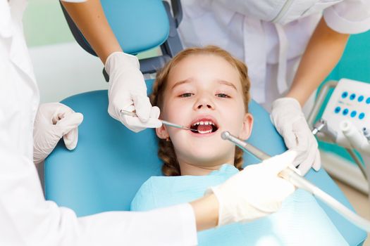 Little girl sitting in the dentists office