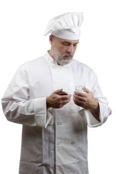 Portrait of a caucasian chef in his uniform on a white background.