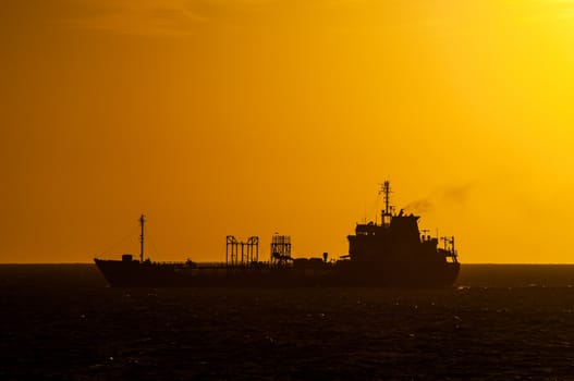 Beautiful dark silhouette of a boat at sunset in Montevideo