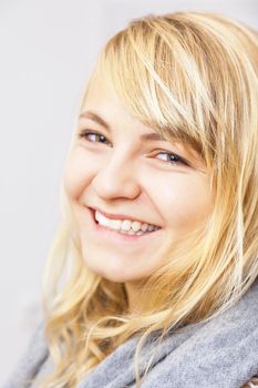 An image of a beautiful smiling blond girl