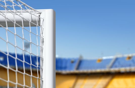 white goalkeeper gate on big empty stadium