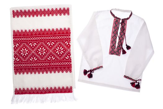 National Ukrainian traditional ornate handicraft symbol embroidery in red cross-stitch handmade white towel and cotton vyshyvanka men’s shirt with ornamental pattern isolated