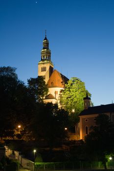 Chapel and bell-tower in old European city in the evening