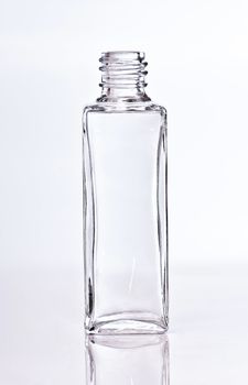 empty glass perfume bottle on a light backgroung