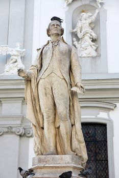 statue of musician Franz Joseph Haydn near The Baroque Church of Mariahilf in Vienna, Austria