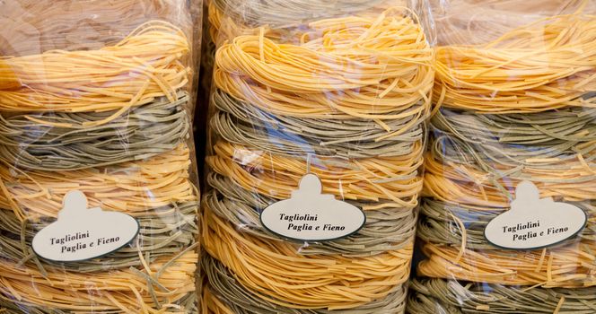 Packed italian egg yellow and spinach pasta tagliatelle at store