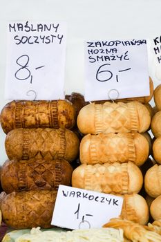 Homemade smoked polish cheese oscypki close-up on the craft market counter in Zakopane