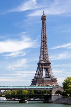 European national landmark Eiffel tower on the bank of Seine river in city Paris France on the blue sky background