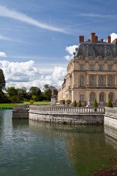 Medieval landmark royal hunting castle Fontainbleau near Paris in France and lake