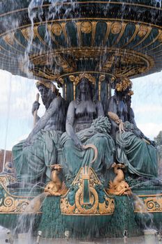 Landmark famous sculptural fountain of River Commerce and Navigation on the Place de la Concorde in Paris France on the cloudy sky background