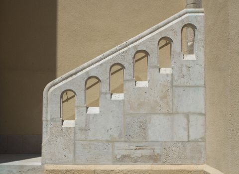 Outside stairs and white stone handrail. Architectural element in Mediterranean style