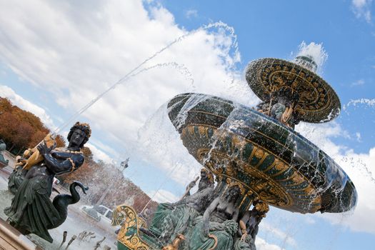 Landmark famous sculptural fountain of River Commerce and Navigation on the Place de la Concorde in Paris France on the cloudy sky background