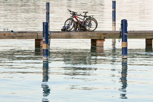 Bicycles are left on the lake bridge. Tranquil scene