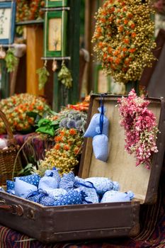 Dried wild flowers and calico bags with lavender in old fashioned suitcase