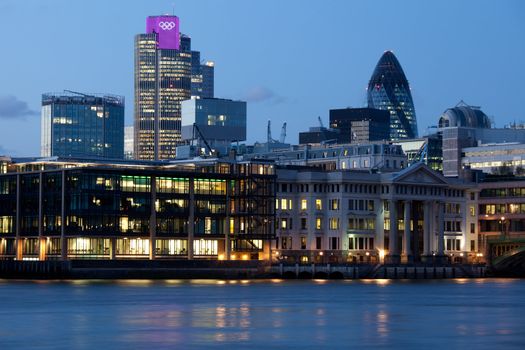 London City, leading center of global finance on Thames river bank. View on Tower 42 Gherkin, illuminated with Olympic rings, Willis Building, Stock Exchange Tower and Lloyd`s of London Great Britain 2012