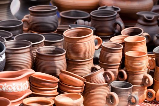 Rustic handmade ceramic clay brown terracotta cups souvenirs at street handicraft market
