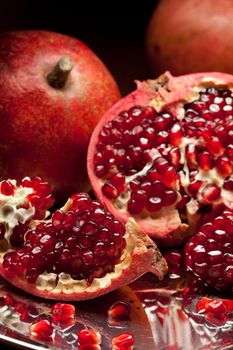 Pomegranate slices and seeds on silver salver