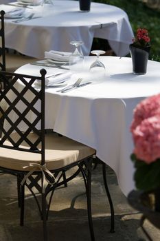 Set table for two on the summer terrace and free chair