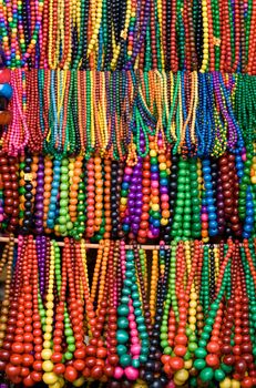 Handicraft wooden many-colored beads on the craft market