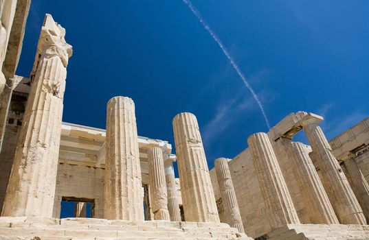 Columns of entrance propylaea to ancient temple Parthenon in Acropolis Athens Greece on blue sky background