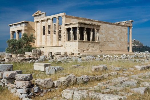 Ancient Temple Erechtheion and The Porch of the Caryatids in Acropolis Athens Greece on blue sky background