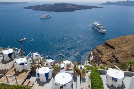 Seascape on volcanic caldera as seen from the restaurants’ terrace along cliffs in Fira, Santorini island capital, Greece