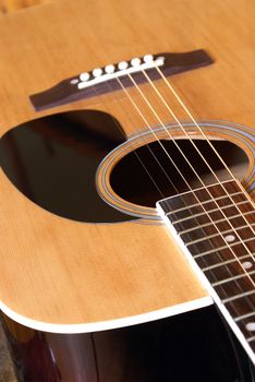 A closeup shot of an acoustic guitar.
