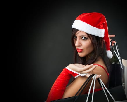Portrait of Beautiful sexy girl wearing santa claus clothes with shopping bag