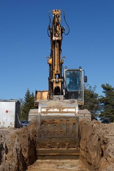 Construction of new street. excavators digging sewer trench