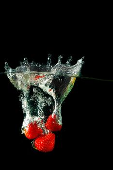 Colored red paprika in water splashes on black background