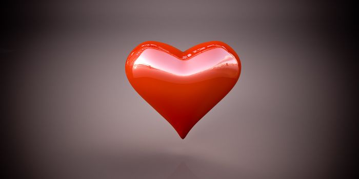 Shiny red heart on a dark gray background, vignetting