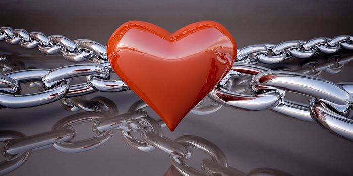 Shiny red heart and a chain on a dark gray background