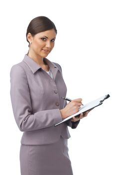 Portrait of a young businesswoman writing something in her folder and smiling