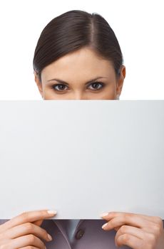 Closeup portrait of a young girl hiding behind an empty white billboard , isolated on white 