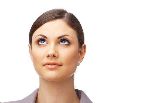 Closeup of a thoughtful young woman looking up over white background 