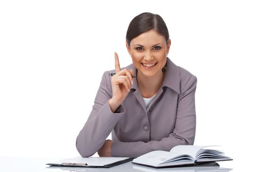 Portrait of a young businesswoman pointing her finger with clipboard, pe and diary over white