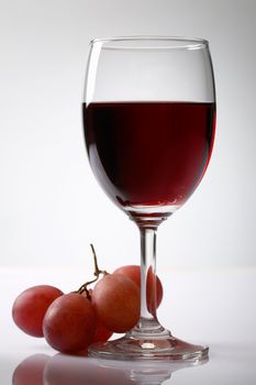 Grape and red wine on white background