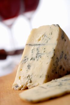 Roquefort soft blue french cheese.  A wine at background