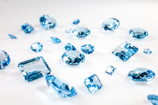 sapphire of different sizes on a white frosted glass
