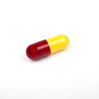 A solitary Pill on a white background.