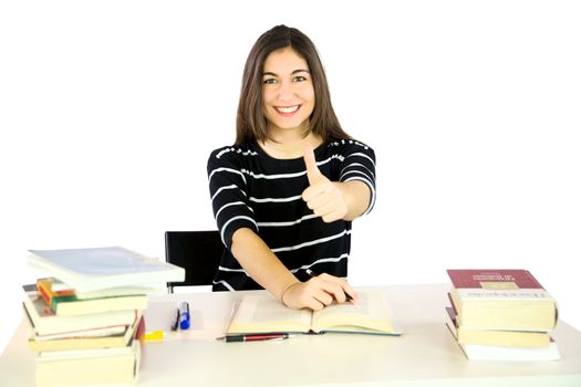 Young student thumb up smiling studying many books