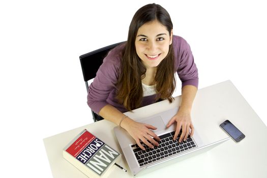 Happy young woman studying on a desk with computer
