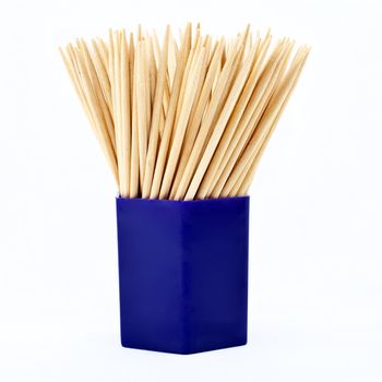 A jar of tooth picks over a white background.