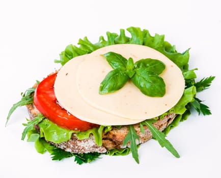 sandwich with ham,cheese and vegetables on white background