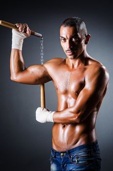Strong man with nunchaku
